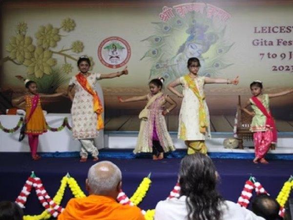 Children performing on stage at a Gita Festival